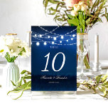 Blue Night and Silver String Lights Wedding Table Number<br><div class="desc">Make your wedding reception even more enchanting with the Blue Night and Silver String Lights Wedding Table Number by Mylini Design. This customizable table number adds a romantic touch to any venue with its beautifully designed blue night background and shimmering silver string lights. Each table number is tailored to your...</div>