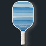 Blue Pastel Watercolor Striped Pickleball Paddle<br><div class="desc">Take your pickleball game to the next level with this stylish paddle, showcasing a beautiful watercolor stripe design in various shades of pastel blue. The elegant aesthetic will make you stand out on the court. Featuring a comfortable grip and a customizable name option, this paddle combines performance with personalized design....</div>
