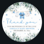 Blue Santa Baby Clothesline Christmas Baby Shower Classic Round Sticker<br><div class="desc">Add a festive touch to your winter baby shower favors with our Blue Santa Baby Clothesline Christmas Baby Shower Classic Round Sticker 🎄💙. Featuring adorable blue baby clothes hanging on a holiday clothesline with delicate snowflakes and winter greenery, this charming design is perfect for sealing envelopes, decorating treat bags, or...</div>