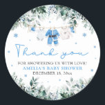 Blue Santa Baby Clothesline Christmas Baby Shower Classic Round Sticker<br><div class="desc">Add a festive touch to your winter baby shower favors with our Blue Santa Baby Clothesline Christmas Baby Shower Classic Round Sticker 🎄💙. Featuring adorable blue baby clothes hanging on a holiday clothesline with delicate snowflakes and winter greenery, this charming design is perfect for sealing envelopes, decorating treat bags, or...</div>