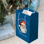Blue Santa Claus Personalized Kids Christmas Medium Gift Bag<br><div class="desc">Customize this nostalgic from Santa Claus blue gift bag with your own personalized text with your kids name in white script. This beautiful old fashioned drawing of Santa's red hat and white beard are the perfect holiday present bags for your children's presents under the tree on Christmas day.</div>
