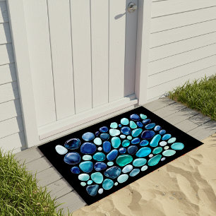 Blue Sea Glass pebbles on a sleek black Doormat