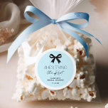 Blue She's Tying The Knot Bow Classic Round Sticker<br><div class="desc">Add a touch of elegance to your bridal shower favors with these blue and black round stickers featuring a classic bow design. Perfect for sealing invitations,  decorating party favors,  or personalizing gifts,  these chic stickers are easy to edit. Matching items in our store Cava Party Design.</div>