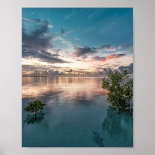 blue sky with red and dark clouds reflected on sea poster