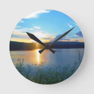 Blue sunset on lake round clock