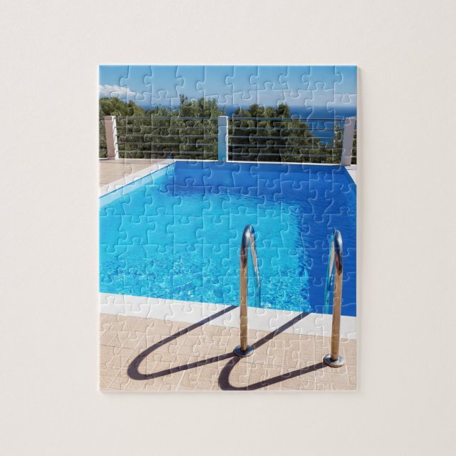Blue swimming pool with steps at sea jigsaw puzzle (Vertical)