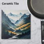 Blue Tan Mountain Scene Ceramic Tile<br><div class="desc">This captivating ceramic tile presents a breathtaking mountain scene, masterfully rendered in soothing shades of blue and tan that evoke a sense of serenity and awe. At the heart of the composition, a crystal-clear stream meanders gracefully down the mountain, its waters reflecting the sky's azure hue, creating a harmonious blend...</div>