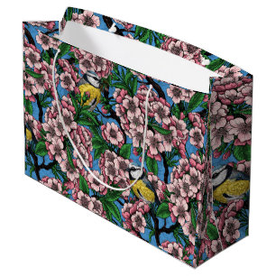 Blue tit birds in the blooming cherry tree on blue large gift bag