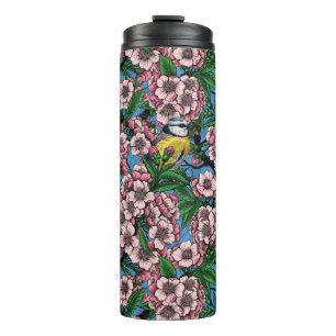 Blue tit birds in the blooming cherry tree on blue thermal tumbler