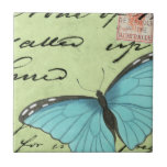 Blue-Winged Butterfly on Teal Postcard Ceramic Tile<br><div class="desc">This teal postcard carries a message of beauty. A delicate blue-winged butterfly rests on the card,  obscuring some of the script it contains. This Vision Studio print would make a great addition to your home!</div>