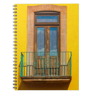 Blue wooden door on yellow concrete building notebook