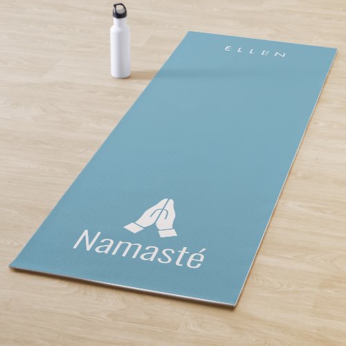 Blue yoga mat with Namast hands together icon