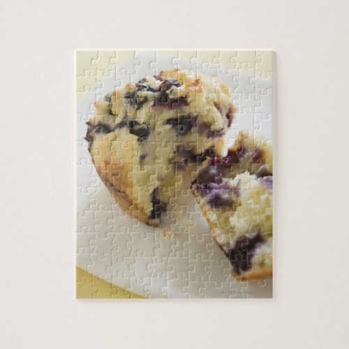 Blueberry muffin split open on a white plate jigsaw puzzle