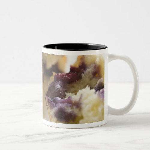 Blueberry muffin split open on a white plate Two_Tone coffee mug
