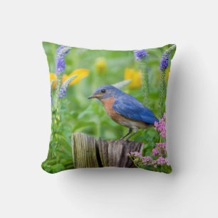 Bluebird male on fence post in flower garden throw pillow