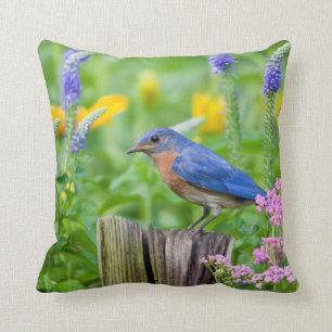 Bluebird male on fence post in flower garden throw pillow