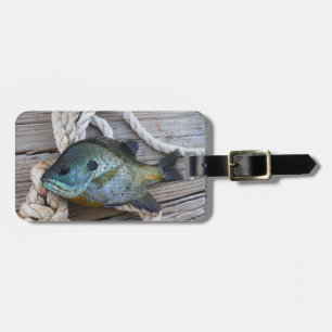 Bluegill fish on dock and rope luggage tag