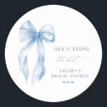 Blush Blue Bow She's Tying the Knot Bridal Shower Classic Round Sticker<br><div class="desc">Welcome your guests in style with our **Blue She's Tying The Knot Bridal Shower Welcome Foam Board**. Featuring a romantic and whimsical design, this foam board is adorned with a soft blue bow, adding a touch of elegance to your bridal shower decor. The charming bow and delicate script set a...</div>