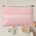 Blush Pink Modern Typography Bridesmaid Accessory Pouch<br><div class="desc">Solid blush pink color, small style, zippered cosmetic bag for your wedding bridesmaid that features the word, BRIDESMAID in large, modern typography on one side of bag. Perfect as a travel accessory pouch to hold makeup, perfume, and jewelry. You may personalize by adding bridesmaid name if desired to pouch. Available...</div>