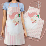 Blush Pink Vintage Winking Santa Christmas Apron<br><div class="desc">This Blush Pink Vintage Winking Santa Christmas Apron features an antique Santa Claus graphic that's been recolored and reimagined. The background is a monochromatic tri-tone ( blush pink, rose quartz, and white) vertical stripe pattern. The straps are a creamy beautiful dusty blush pink, borderline rose gold / mauve, but not...</div>