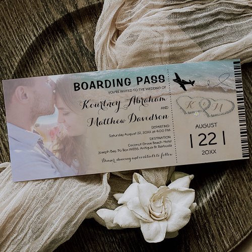 Boarding Pass Beach Photo Wedding Invitation - Boarding pass destination wedding invitation featuring a photo of the happy couple, an ocean beach background, two love hearts in the shoreline, your initials, an airplane, and a personalized wedding template.