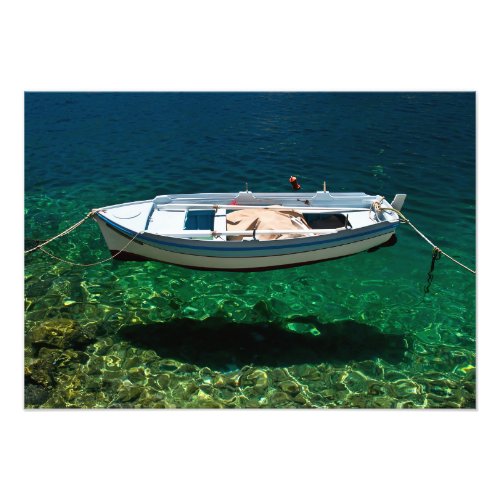 Boat floating on crystal clear water photo print