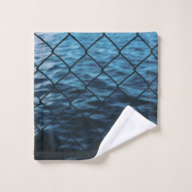 Body of water in front of chain link fence wash cloth (Wash Cloth)