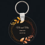 Boho autumn botanical gold frame wedding keychain<br><div class="desc">Set against a striking black background, this keychain features apricot-colored text that provides a warm and inviting touch. Delicate leaves in soft muted earth tones and earthy autumnal copper shades evoke the cozy charm of autumn, while the geometric frame in burnt orange and terracotta adds a rustic yet sophisticated flair....</div>