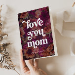 Boho Retro Text | Love you Mom Bold Floral Holiday Card<br><div class="desc">This boho and stylish folded card says "love you mom" in trendy boho and retro typography,  on a pretty background of bold,  dark flowers in pink and purple shades. The inside of the card features your favorite personal photo. The perfect card for Mother's Day or any time!</div>