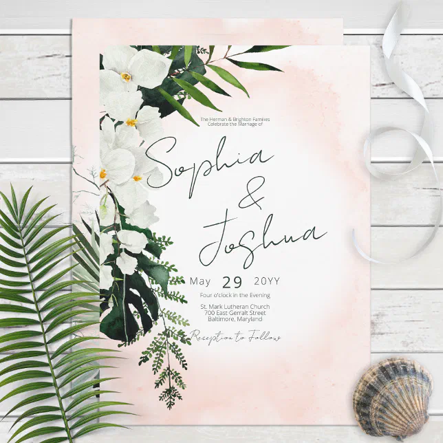 A tropical-themed wedding invitation featuring a white and green color scheme. A palm leaf and seashell are pictured nearby.