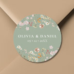 Boho Wildflower Sage Green Garden Wedding Classic Round Sticker<br><div class="desc">Add a charming touch to your wedding stationery or favors with our Boho Wildflower Garden Wedding Classic Round Sticker. Featuring delicate wildflower illustrations on a soft beige background, this versatile sticker is perfect for sealing envelopes, adorning favor bags, or adding a personal touch to decor. Its elegant design complements a...</div>