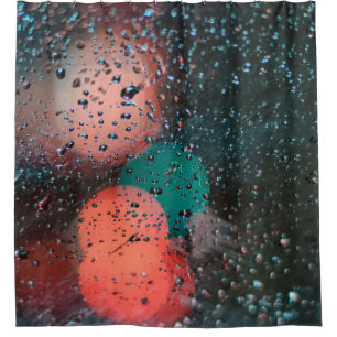 Bokeh photography of water droplets on clear glass shower curtain
