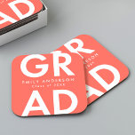 Bold Grad Coral Graduation Party Square Paper Coaster<br><div class="desc">Custom graduation paper coasters featuring "Grad" in bold white lettering with a coral background. Personalize the graduation coasters by adding the graduate's name and graduation year. The personalized graduation coasters are perfect for both high school and college graduation parties.</div>
