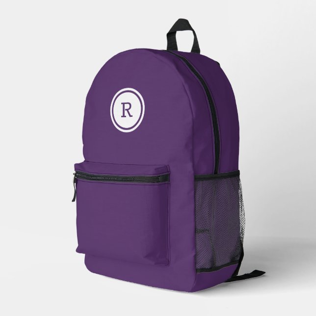 Bold Monogram in White Circle on Purple Printed Backpack (Back Corner Right)