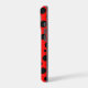 Side view of a red and black polka dot phone case design
