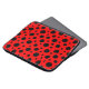 Laptop sleeve with a red and black polka dot design