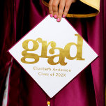 Bold simple modern gold typography on white graduation cap topper<br><div class="desc">Your favorite grad will stand out and make a statement when they wear this graduation cap topper! Let them celebrate their milestone with this stunning, simple, modern, custom graduation keepsake. Bold, graphic, faux gold foil typography overlays a white background. Personalize with your grad’s name and class year. Matching announcements, address...</div>