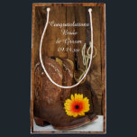 Boots, Daisy and Horse Bit Congratulations Wedding Small Gift Bag<br><div class="desc">Fill the charming Cowboy Boots, Daisy and Horse Bit Congratulations Country Wedding Gift Bags with your present for the newlyweds. These charming custom equine theme wedding congrats bags feature a quaint digitally enhanced floral photograph of a pair of brown leather western cowboy boots, a yellow orange daisy flower blossom, horse...</div>