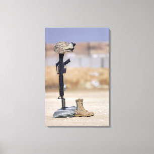 Boots, rifle, dog tags, and protective helmet canvas print