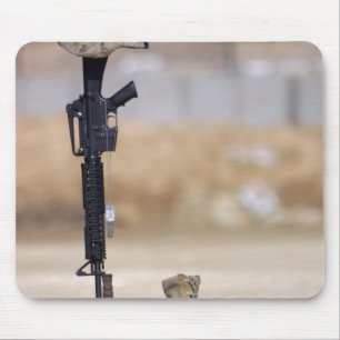 Boots, rifle, dog tags, and protective helmet mouse pad