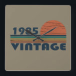 born in 1985 vintage birthday square wall clock<br><div class="desc">You can add some originality to your wardrobe with this original 1985 vintage sunset retro-looking birthday design with awesome colors and typography font lettering, is a great gift idea for men, women, husband, wife girlfriend, and a boyfriend who will love this one-of-a-kind artwork. The best amazing and funny holiday present...</div>