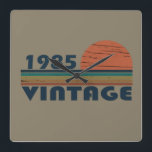 born in 1985 vintage birthday square wall clock<br><div class="desc">You can add some originality to your wardrobe with this original 1985 vintage sunset retro-looking birthday design with awesome colors and typography font lettering, is a great gift idea for men, women, husband, wife girlfriend, and a boyfriend who will love this one-of-a-kind artwork. The best amazing and funny holiday present...</div>