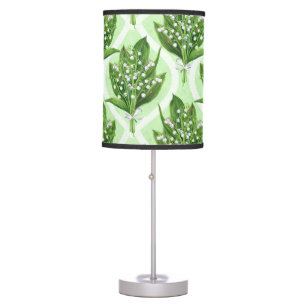 Bouquet of lilly of the valley flowers on green table lamp