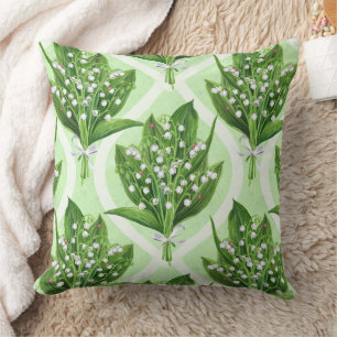 Bouquet of lilly of the valley flowers on green throw pillow