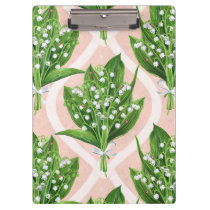Bouquet of lilly of the valley flowers on pink clipboard