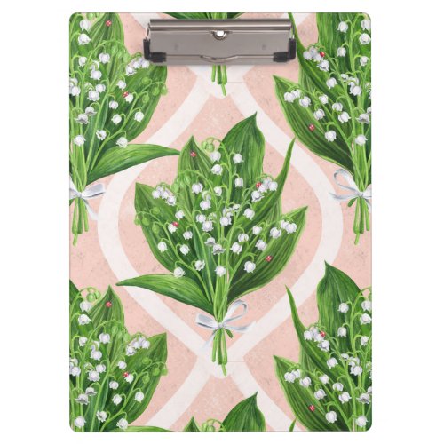 Bouquet of lilly of the valley flowers on pink clipboard