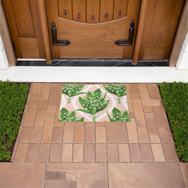 Bouquet of lilly of the valley flowers on pink doormat (Outdoor)