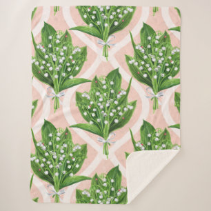 Bouquet of lilly of the valley flowers on pink sherpa blanket
