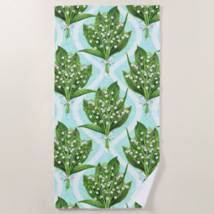 Bouquet of lily of the valley flowers on blue beach towel