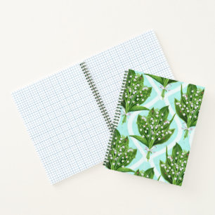 Bouquet of lily of the valley flowers on blue notebook